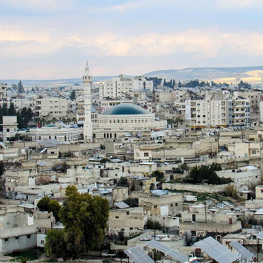 Birds eye view of the white buildings of Hama during the day.