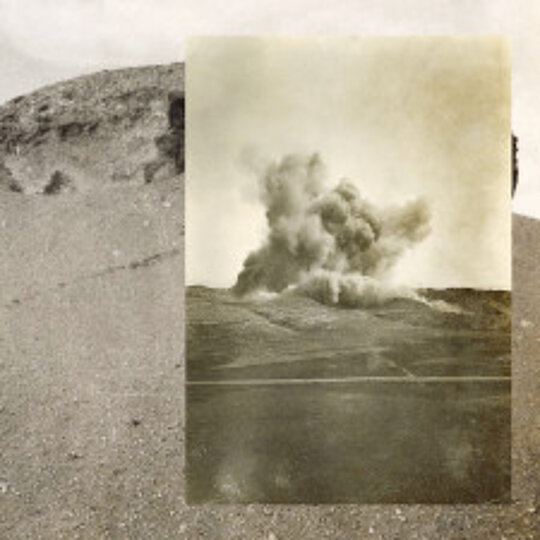 Scenes of Extraction A collage of a photo showing an extraction superimposed on a photo showing a desert landscape, both in sepia